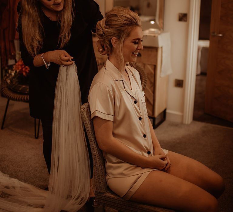 Bride has her hair done on the morning of her wedding day