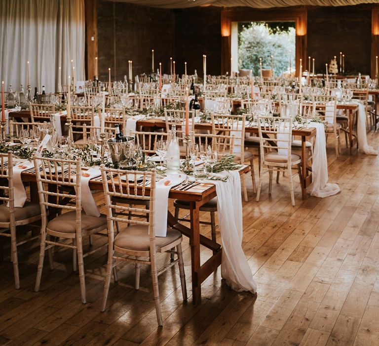 banquet tables at the Gillyflower wedding reception with greenery table runners and candlesticks 