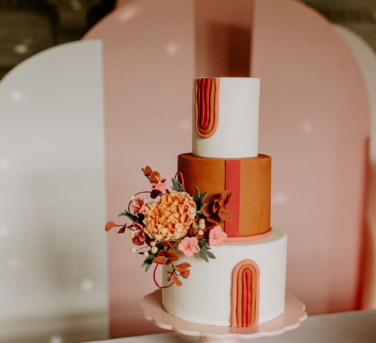 Iced retro wedding cake with orange layer and geometric design 