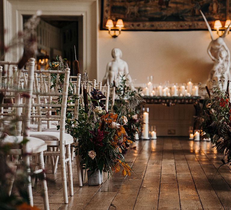 Rustic country house wedding at Elmore Court with statues and autumnal flower displays 