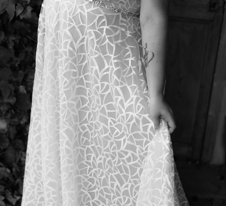 Closer look at the geometric detail on the bride's wedding dress for LGBTQI+ wedding