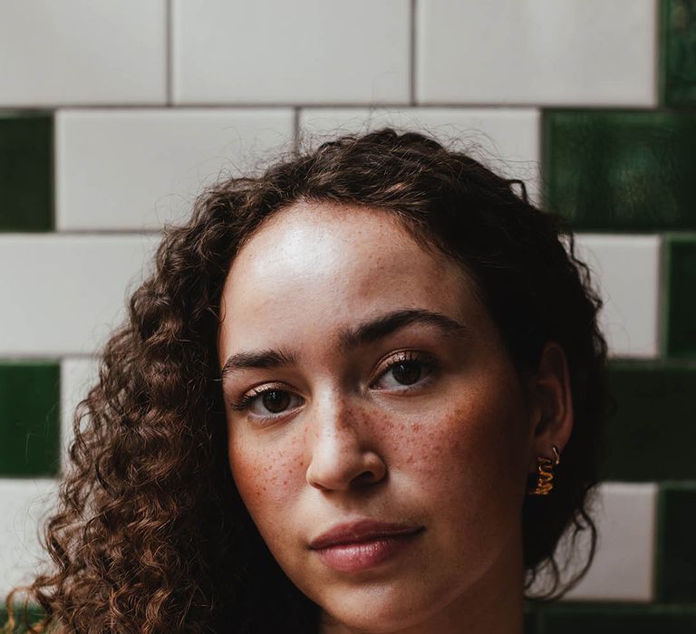 Bride with naturally curly hair and freckles wearing barely there makeup 