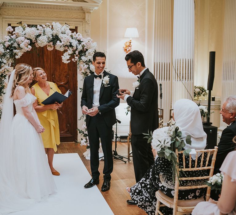 Ring bearer hands over the wedding rings 