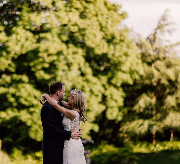 Bride and groom share a private moment together as they look out over the gardens at Goldney Hall 