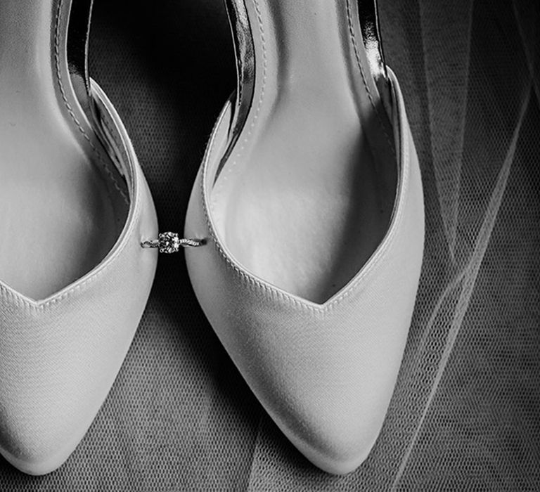 White wedding heels from Rainbow Club with the bride's brilliant round engagement ring