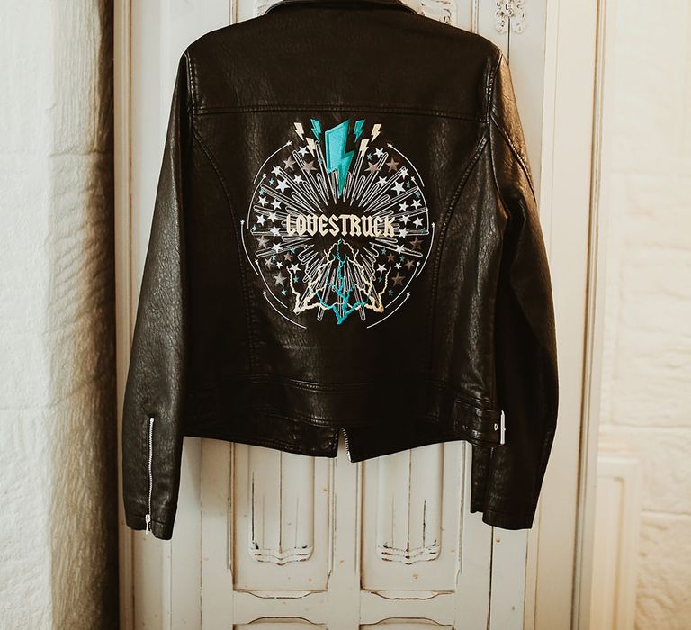 Personalised leather jacket with 'Lovestuck' written across the back within colourful silver design