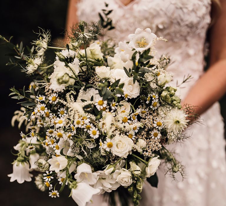 White flower wedding bouquet held by the bride for a rustic barn wedding 