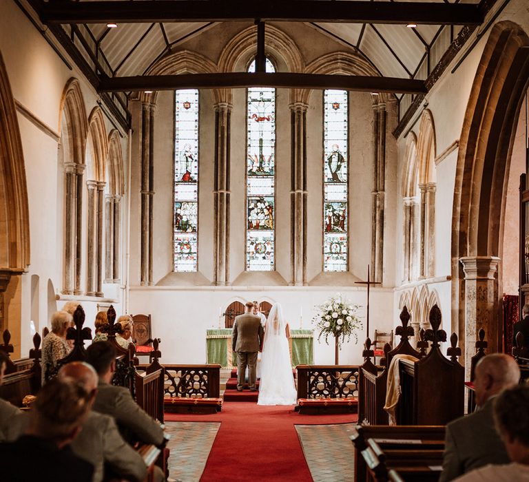 Bride and groom stand at the altar for their church wedding ceremony 