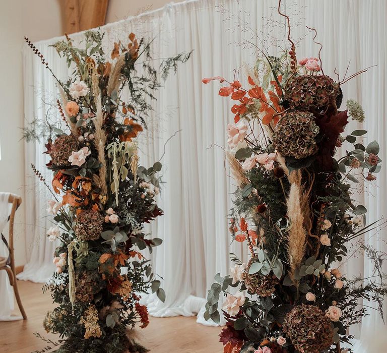 Boho autumnal flower columns with pampas grass and autumn leaves 