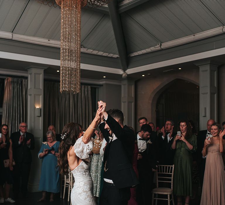 The bride and groom have their first dance together 