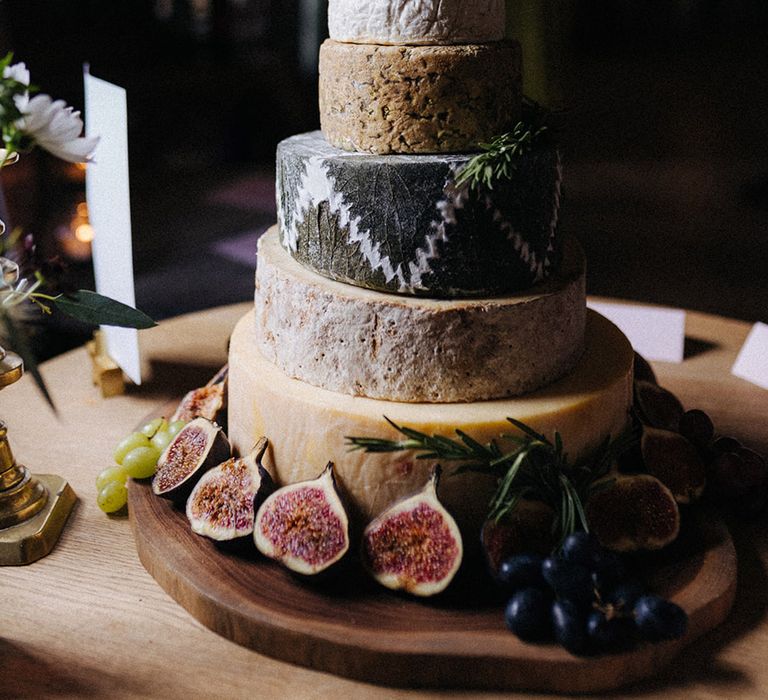 Wedding cheese tower with 6 layers of cheese with green grapes and figs 