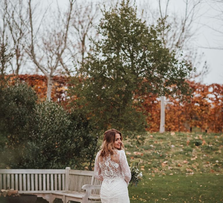 Bride in lace back winter wedding dress with pretty tulle train for the Stone Barn wedding 