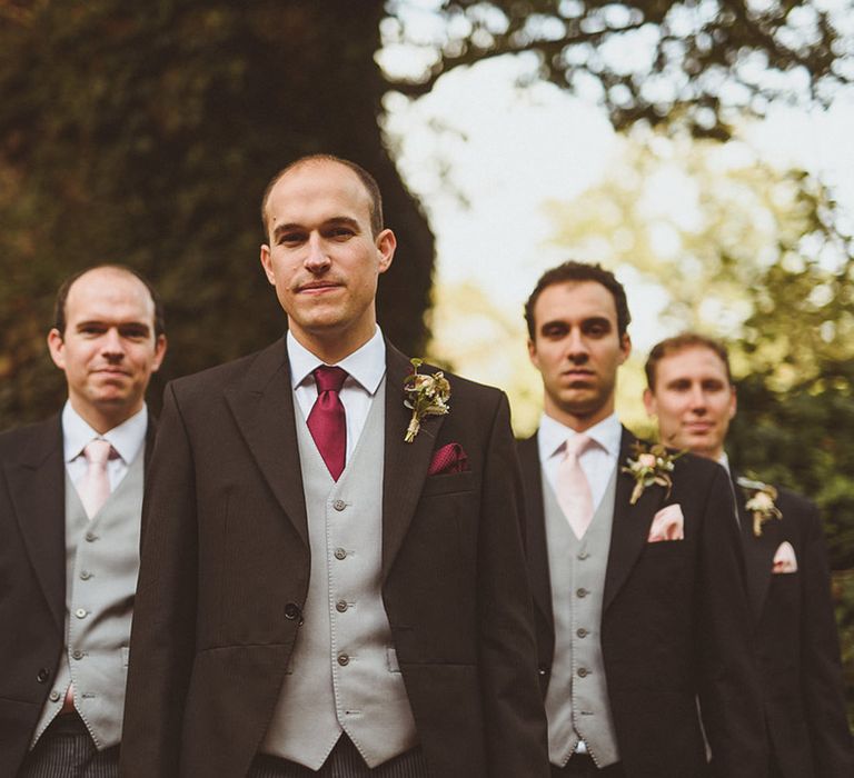 Groom and groomsmen pose together for the traditional Ramster Hall wedding 