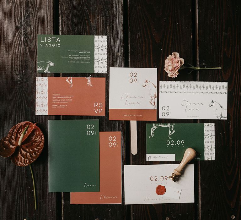 flat lay of green and orange wedding stationery suite