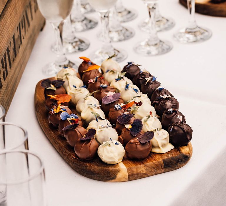 Platter of chocolate favours with edible flowers grown by the couple 