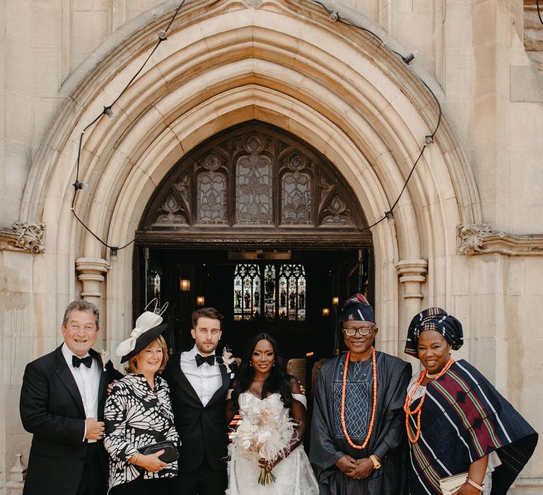 Formal group wedding family photo outside of the church for wedding day 