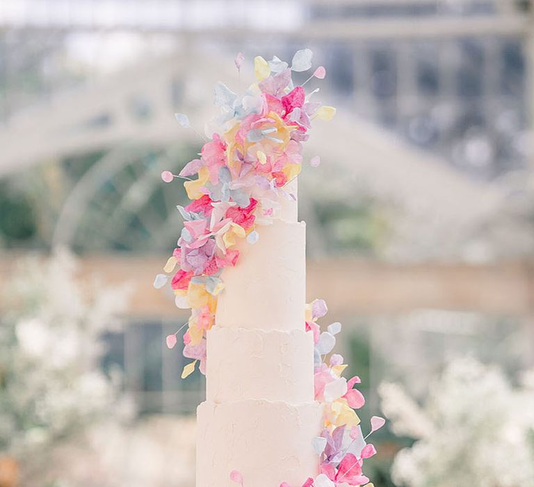 Tall tiered wedding cake with pastel flower design for summer wedding 