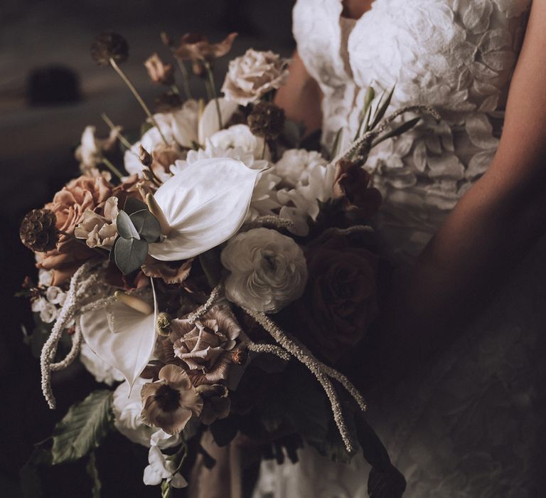 Neutral wedding bouquet with anthuriums and autumnal flowers 