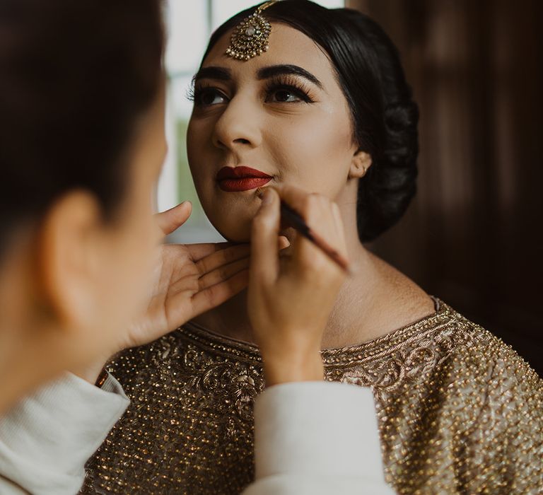 Muslim bride having her makeup done 