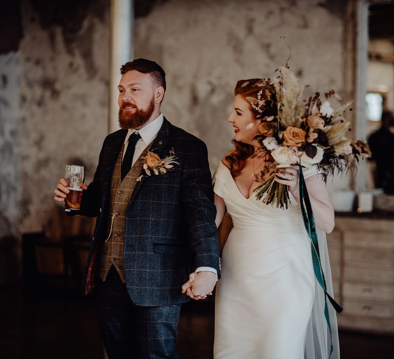 Bride and groom holding hands at intimate Holmes Mill wedding 