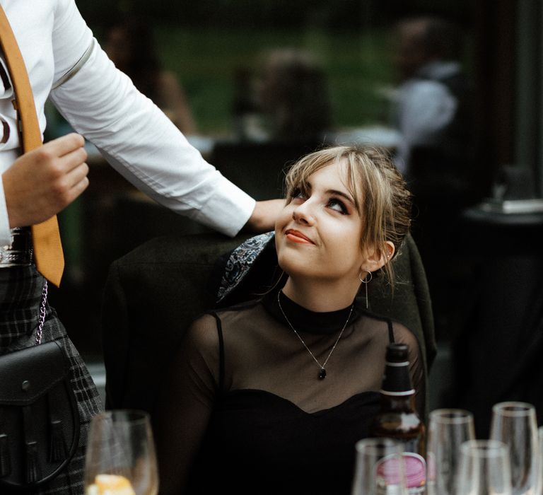 Bride wears black mesh top during wedding speeches