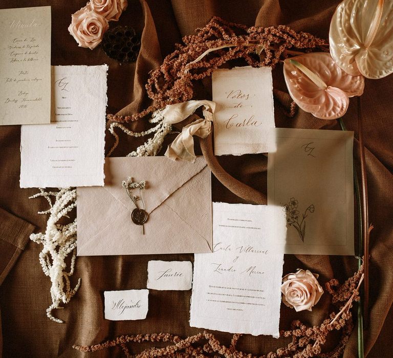 Romantic wedding stationery suite in natural tones with dried grasses and anthurium decor 