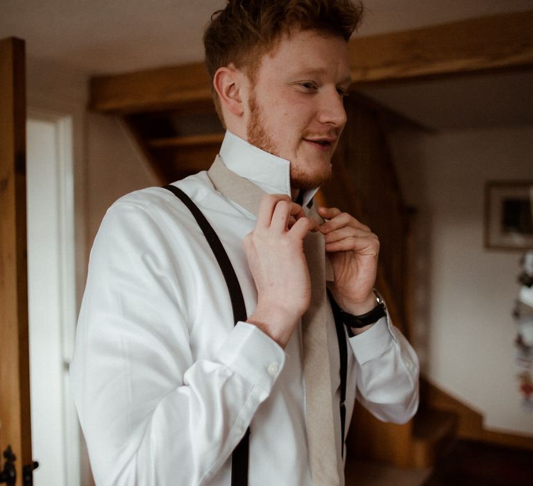 Groom getting ready in his Moss Bros suit