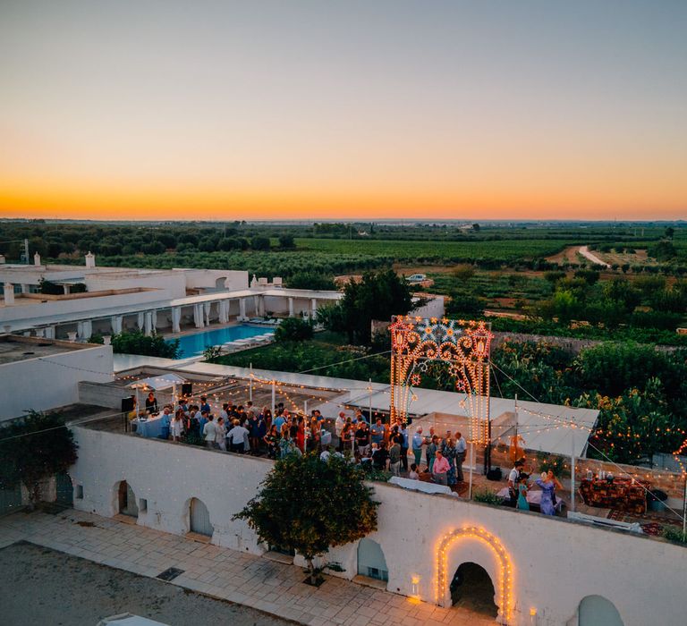 Pre-wedding party celebrations with festoon lighting on the rooftop at Masseria Potenti