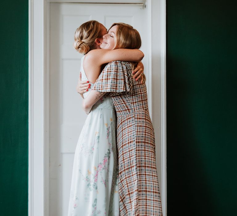 Bride hugs wedding guest on the morning of her wedding day