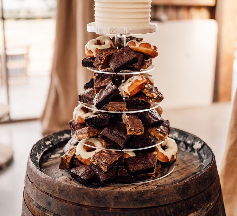 Delicious brownie and doughnut tower with cake at the top