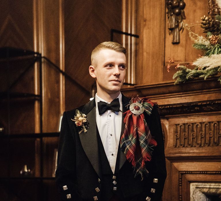 Groom in traditional tartan kilt for elopement