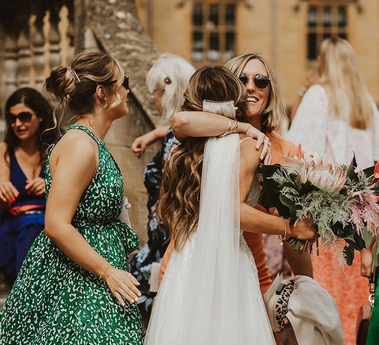 Bride hugs wedding guest on her wedding day