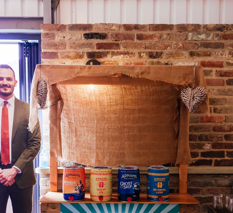 Adnams ale stand with festival style brewery sign on wooden cart for festival inspired wedding