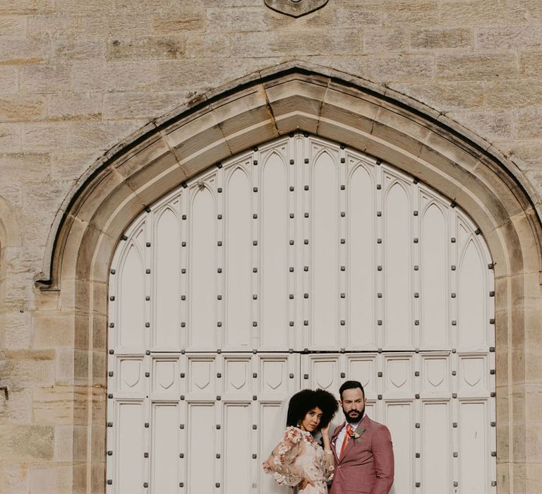 Chiddingstone Castle blush pink wedding inspiration with embroidered wedding dress and pink grooms suit 