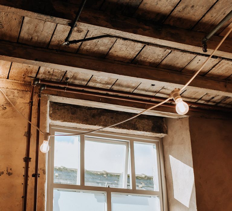 Interior of Mill wedding venue in Lancashire with bulb string lights