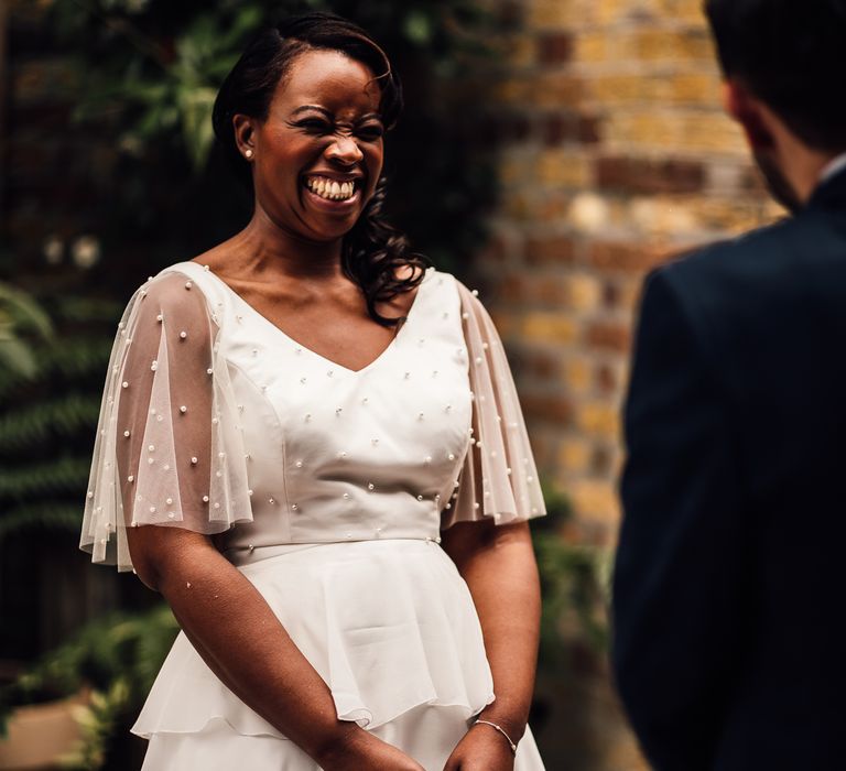 Black bride in layered ruffle wedding dress with pearls on the bodice and sleeves 