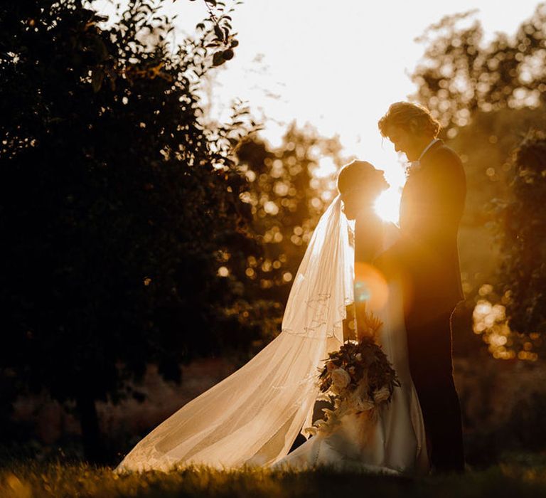 Golden hour portrait of bride and groom at Elmore Court