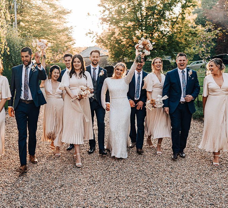 The wedding party all celebrate together outside Pennard House after the wedding ceremony