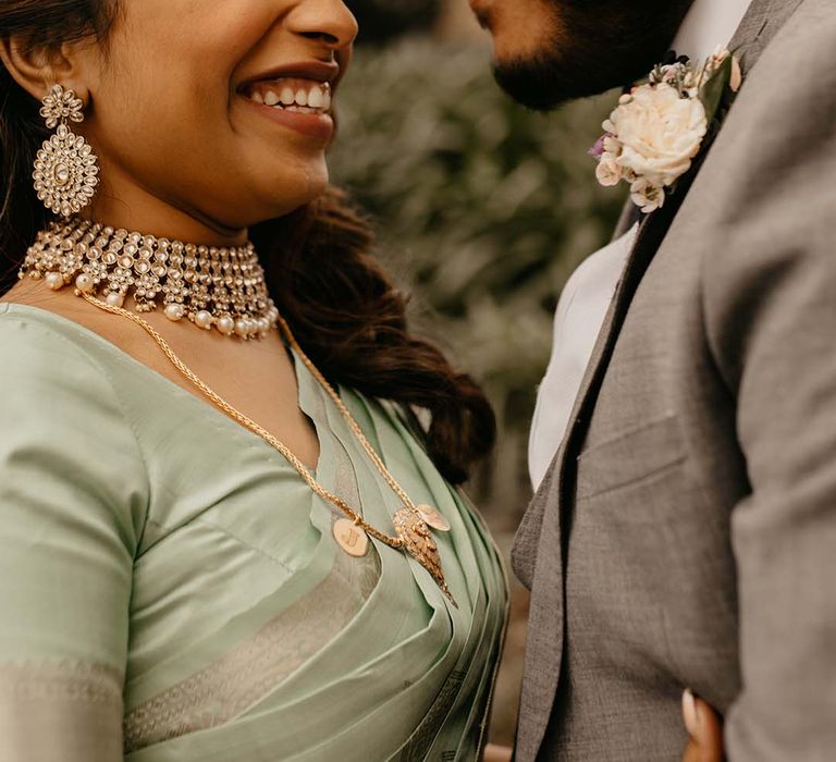 Bride and groom embracing at their multicultural wedding