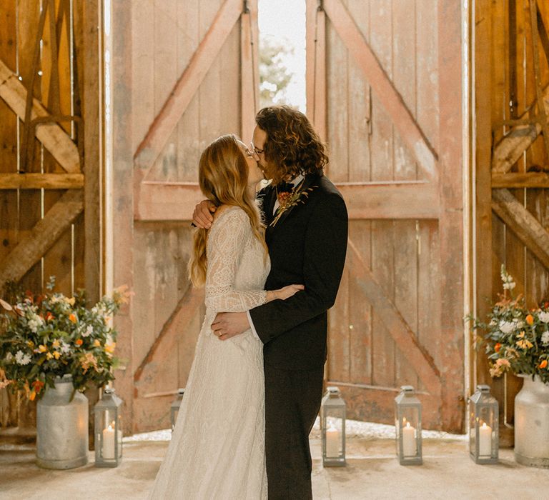 Bride and groom share their first kiss as a married couple at Nancarrow Farm wedding venue