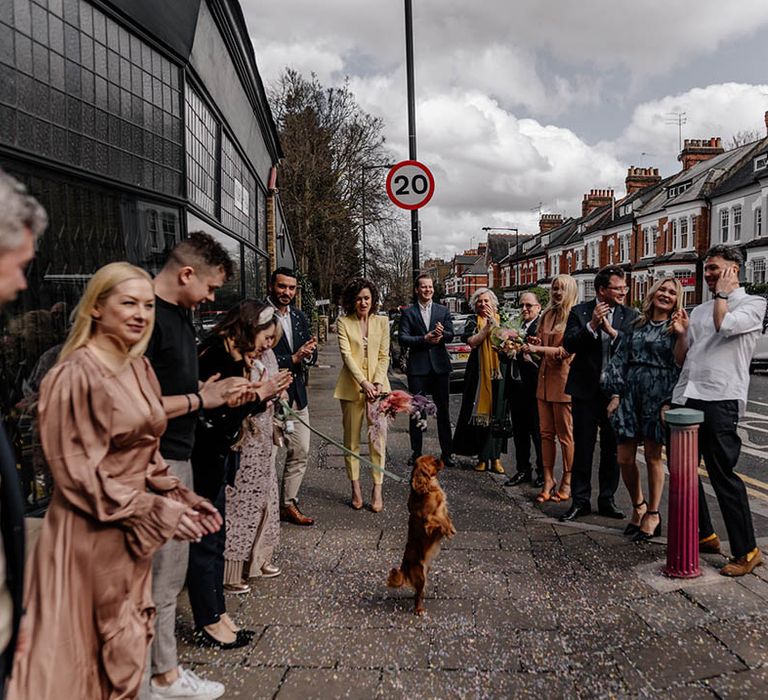 wedding guests lining up to do confetti exit at stylish London wedding 