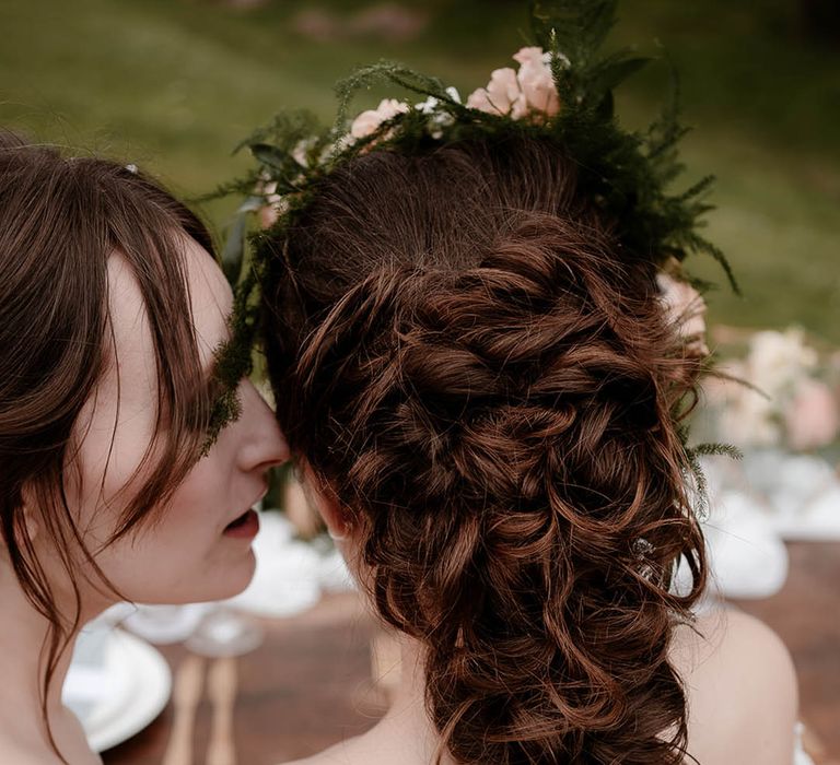 Bride with a loosely pinned fishtail braid wedding hairstyle 