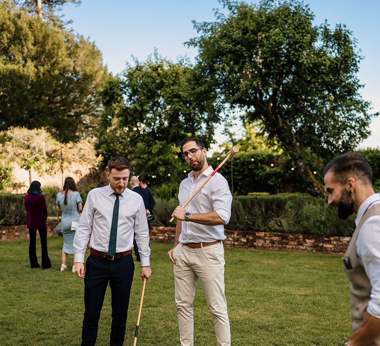 Wedding guests play outdoor garden games at Northbrook Park