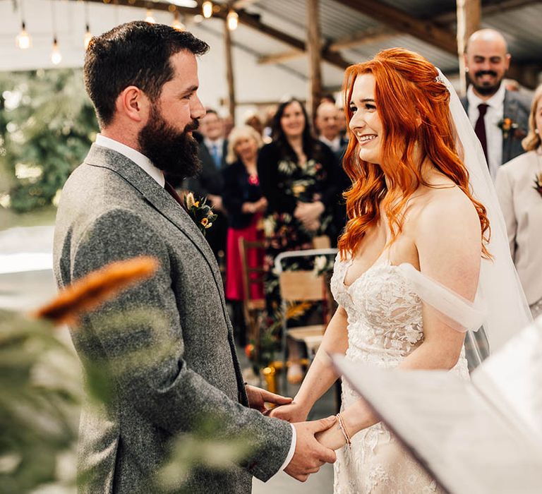 Bride and groom hold hands for their wedding ceremony at White Syke Fields 