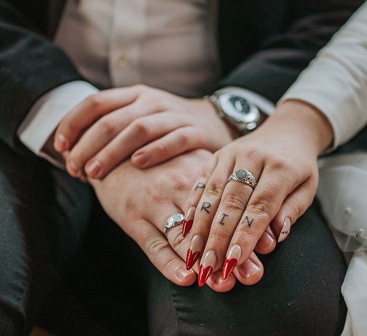 Red tipped pointed manicured bridal nails