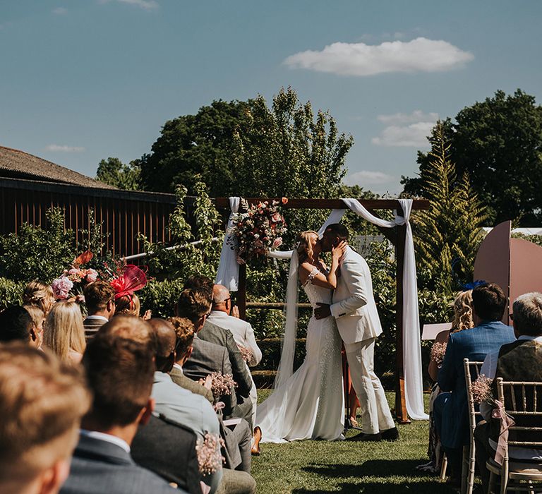 Bride and groom share their first kiss as a married couple