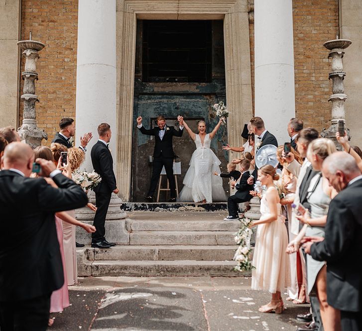 Bride & groom celebrate as they leave The Asylum after wedding ceremony in London