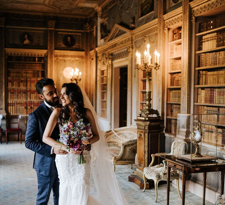 Bride & groom embrace in grand room at Syon Park after first-look moment 