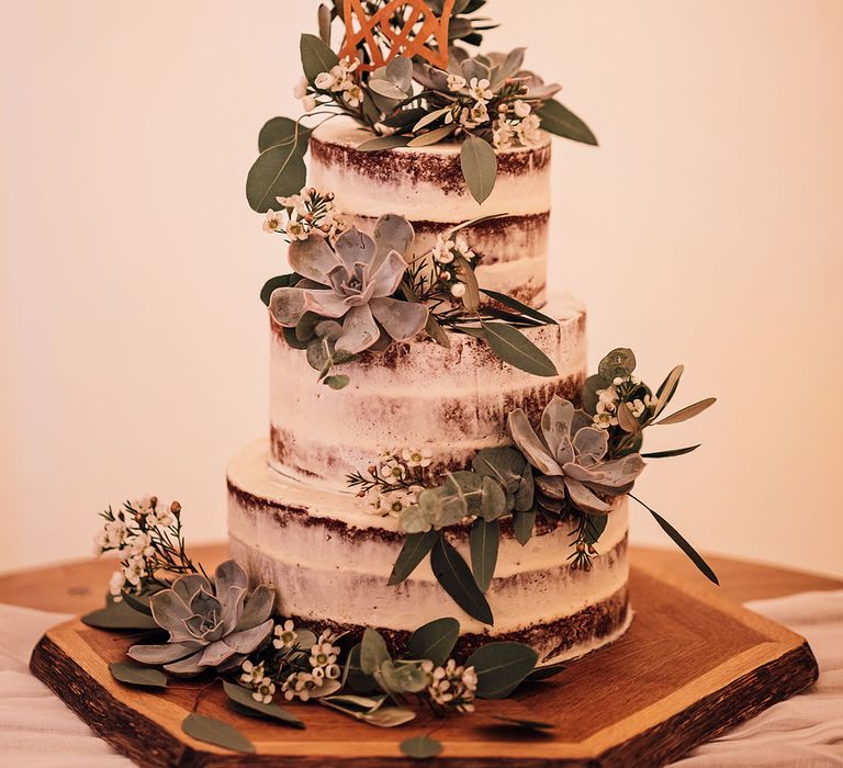 Semi-naked rustic wedding cake with succulent decor 