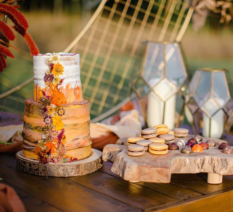 Grey and yellow macaroons on wooden slate at a harvest wedding